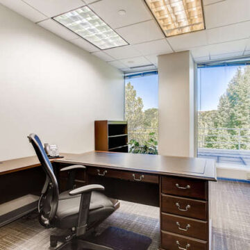 Small office with big windows and chairs