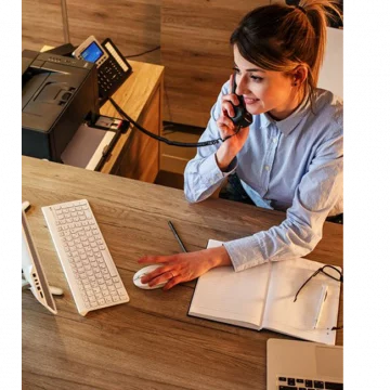 Women working at a desk answering a phone