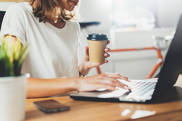 Productive woman working on laptop at her office desk